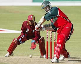 Zimbabwean batsman Mark Vermuelen drives as West Indies wicketkeeper Carlton Baught looks on at the Queens Sports Club in Bulawayo 