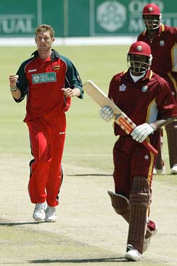 Zimbabwe bowler Andy Bignaut (L) celebrates after dismissing West Indies batsman Chris Gayle