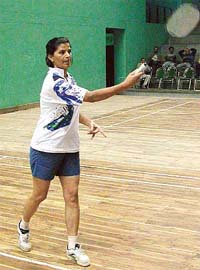 Eight-time Himachal champion Saroj Chowdhry of AG, Haryana, serve to her opponent in the North Zone Indian Audit and Accounts Deaprtment Badminton meet in Sector 42