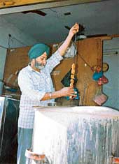 Mohinder Singh checks out a mutton �seekh� at his shop in Patiala