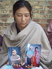 Geeta, Jasbir�s widow, shows old photographs at her in-laws� house at Jahankhelan village in Hoshiarpur district on Wednesday.