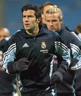 Real Madrid's Portuguese player Luis Figo runs with David Beckham during a training session at Velodrome Stadium in France 