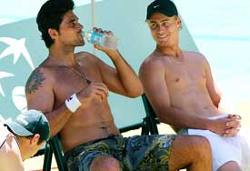 Australian tennis players Lleyton Hewitt and Mark Philippoussis share a laugh during a practice session in Melbourne