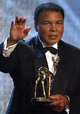 Former heavyweight boxing legend Muhammad Ali waves as he holds his Bambi award