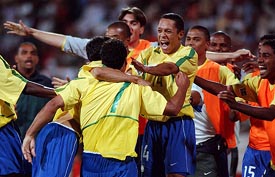 Brazil's Daniel Carvalho is being congratulated by teammates after he scored the first goal against Canada during their opening match at FIFA's World Youth Soccer championships in Dubai 