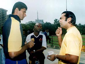 Indian tennis star Leander Paes speaks to former Indian Test cricketer Venkatesh Prasad and Vinod Kambli during a double wicket cricket tournament in Kolkata on Friday