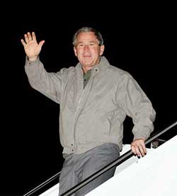 US President George W. Bush walks down the steps of Air Force One after returning to Texas following his surprise Thanksgiving Day trip to Iraq