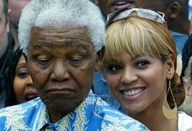 Nelson Mandela poses for photographers with singer Beyonce Knowles during a visit to Robben Island Prison near Cape Town 