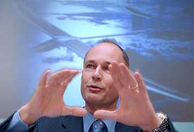 Bertrand Piccard, the first man together with Briton Brian Jones to circumnavigate the world non-stop in a balloon in 1999, gestures during a news conference at Lausanne, Switzerland