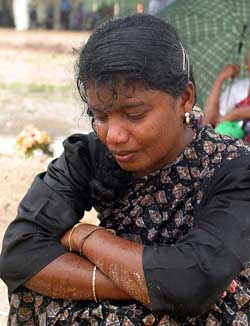 A young Tamil woman mourns at a war cemetery in Kilinochchi, Sri Lanka