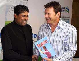 Nick Faldo, one of the greatest golfers of all time, presents the book - Golf The Nick Faldo Way to former cricketer Kapil Dev at a Press conference in Mumbai 