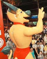 An electronic mascot of the 22nd SEA Games ��the Golden Buffalo�� entertains passers-by outside an electronics complex in downtown Ho Chi Minh city