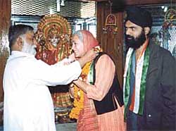 PLEASE GOD: Social activist Nafisa Ali being greeted at the Prachin Mahavir Mandir, Kashmiri Gate where she tries to seek the Lord�s blessings for the Congress victory. She was accompanied by Jaswinder Singh Honey, president, Youth Akali Dal (MTS) in the Capital on Sunday