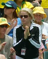 Belgian tennis star Kim Clijsters, who's also the girlfriend of Australian tennis player Lleyton Hewitt, applauds Australia's Mark Philippoussis after he beat Spain's Juan Carlos Ferrero in the reverse singles match of the Davis Cup final