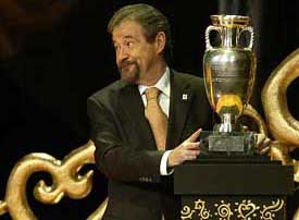 President of Euro 2004 Gilberto Madai receives the European championship trophy from UEFA during the draw for Euro 2004 in Lisbon