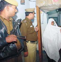 An old woman comes out of the booth after casting her vote