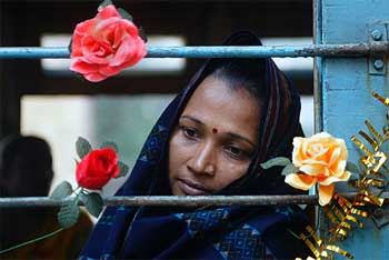 A sex worker looks out the window of a decorated tram which was being used as part of an AIDS prevention awareness campaign on World AIDS Day