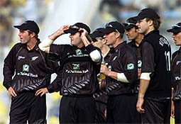 New Zealand players anxiously wait for the third umpire's decision on Pakistan batsman Shoaib Malik during the second one-day international in Lahore 