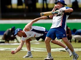 England coach Duncan Fletcher gives catching practice to Nasser Hussain during a training session in Galle