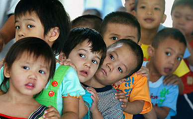 Young AIDS patients share a rare happy moment while queueing up for lunch at the Phyathai Babies� Home Foundation in Bangkok