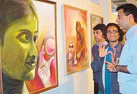 Local painter Bobby explains his creation to Mr Randeep Singh Surjewala, president of the All-India Youth Congress, at Punjab Kala Bhavan in Chandigarh on Tuesday.