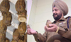 SSP Gurkirpal Singh shows hand-grenades and detonators recovered from one Major Singh