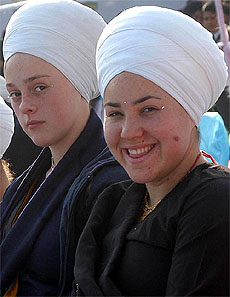 American Sikhs girls in traditional Punjabi attire sit in a row at the rehearsal of the Amritsar Heritage Festival