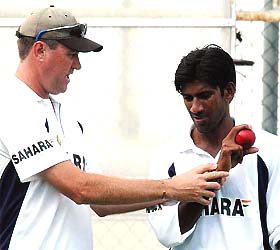 Indian cricket team's bowling coach Bruce Reid gives tips to pace bowler Laxmipati  Balaji during a practice session in Queensland