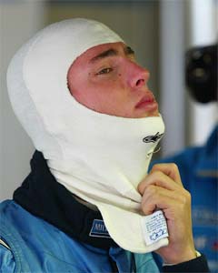 Argentine Formula One test driver Jose Maria Lopez adjusts his balaclava during Formula One testing at Barcelona's Montmelo racetrack, Spain, on Tuesday