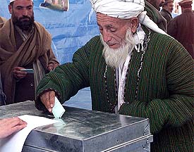 Afghan men cast their votes for provincial delegates at the National stadium in Kabul on Tuesday