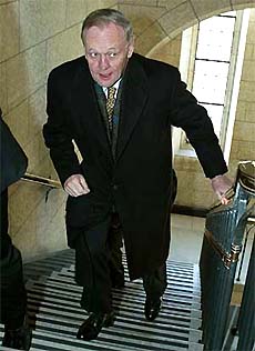 Canadian Prime Minister Jean Chretien runs up the stairs to his office on Parliament Hill in Ottawa on Monday