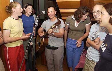 The NewZealand women's cricket team led by their captain Maia Lewis strumming the guitar as they sing and dance at a local club in Mumbai
