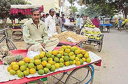 Vegetable vendors sell their wares outside the Apni Mandi in Sector 4, Panchkula, after not being allowed to sell their produce. 