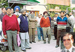Grieving relatives outside the house of Mr Manmohan Munjal, General Manager, Headquarters, Milkfed (inset), who was killed in an accident involving a stray cow.