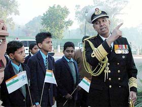 Navy Chief Admiral Madhavendra Singh talks to schoolchildren at the Amar Jawan Jyoti on the occasion of Navy Day in New Delhi