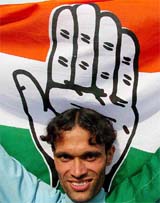 A Congress supporter celebrates Congress's victory at Delhi Assembly Elections outside a counting station in New Delhi on Thursday