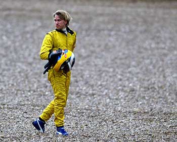 Jordan's driver Nick Heidfeld from Germany walks after leaving the track during a test drive at the Jerez racing track on Thursday