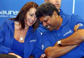Legendary Romanian gymnast Nadia Comaneci speaks to former Indian cricketer Kapil Dev during a meeting of the Laureus World Sports Academy Members at Lonavla