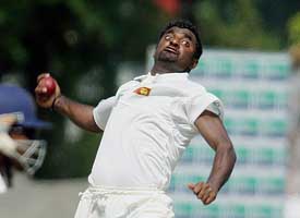 Sri Lankan bowler Muttiah Muralitharan bowls against England on the third day of the first Test match in Galle 