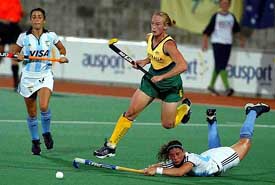 Australia's Megan Rivers jumps over Argentina's Maria Paz Ferrari as she dives for the ball during their Women's Champions Trophy hockey match in Sydney