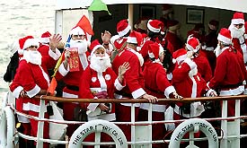 Sixty Santa Clauses from the US and Canada travel onboard a Star ferry during a cruise at Hong Kong Harbour on Thursday