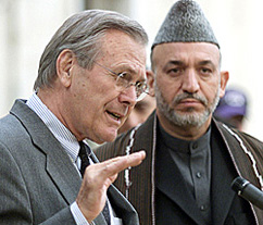 US Secretary of Defence Donald Rumsfeld speaks as Afghan President Hamid Karzai looks on at a Press conference in Kabul 