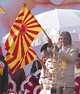 Indian President A.P.J. Abdul Kalam waves a flag after inaugurating Brahm Kumari's peace festival, World Peace Through Spiritual Power in New Delhi on Sunday