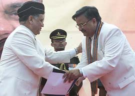 Newly sworn-in Chief Minister of Chattisgarh Raman Singh being congratulated by Governor Lt. Gen. K.M. Seth in Raipur on Sunday