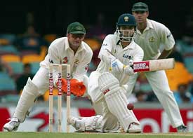 Indian captain Saurav Ganguly sweeps as  Australian wicketkeeper Adam Gilchrist and Matthew Hayden look on on the fourth day of the first Test match between India and Australia in Brisbane