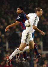 Real Madrid's Zinedine Zidane fights for the ball with Michael Reiziger of FC Barcelona during their Spanish league match in Barcelona