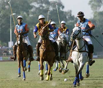 India's Ravi Rathore prepares to hit the ball as Australia's Brodie Donovan tries to stop him from behind during their Polo World Cup qualifying round match in Lahore 