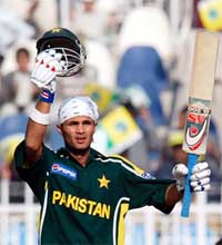 Pakistani opener Imran Farhat acknowledges the crowd's applause after reaching his century 