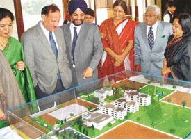 The Principal Secretary, Irrigation, Punjab, Mr K.R. Lakhanpal , is shown a model of the Ananda International School building by the patron of the school