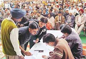 Successful bidders complete documentation at an auction of commercial sites